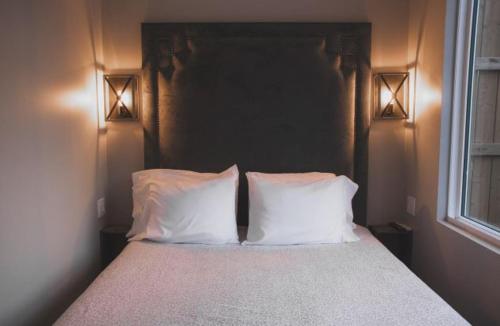 a bedroom with a bed with two white pillows at Inner Joy Getaways in Elora