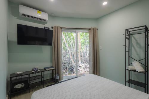 a bedroom with a bed and a large window at Fragata Island House in Isla Grande