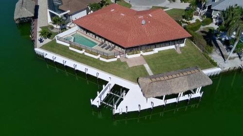 an aerial view of a house on the water at Waterfront Tip Lot Treasure w/ Southern Sunshine in Henry Key