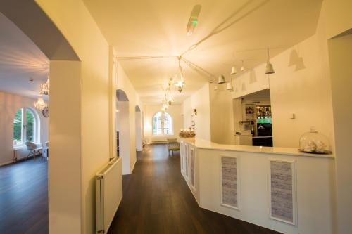 a hallway of a home with a kitchen and a living room at Gray Manor Hotel in Andover