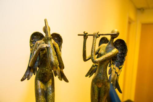 two bronze sculptures of people holding a cross at Gray Manor Hotel in Andover