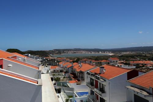 a view of a city with buildings and a river at Bahia's House in Salir de Porto