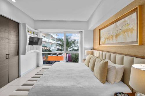 a bedroom with a bed and a television in it at Spectacular Apartment Ocean View Puerto Vallarta in Puerto Vallarta