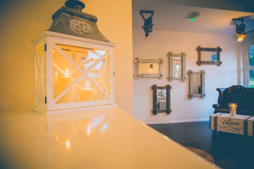 a lantern on top of a table in a room at Gray Manor Hotel in Andover