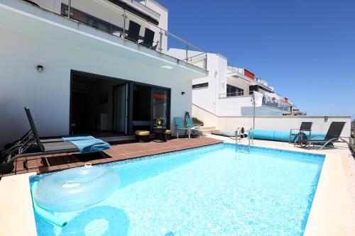 a swimming pool in the middle of a house at Bahia's House in Salir de Porto