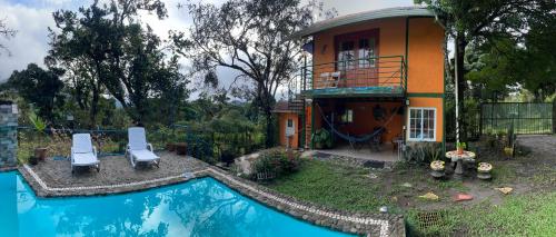 a house with a swimming pool in front of a house at Hostal La India in Valle de Anton