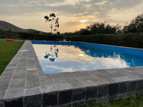 a swimming pool with the sky in the water at Casa Tullpa in Aspitia