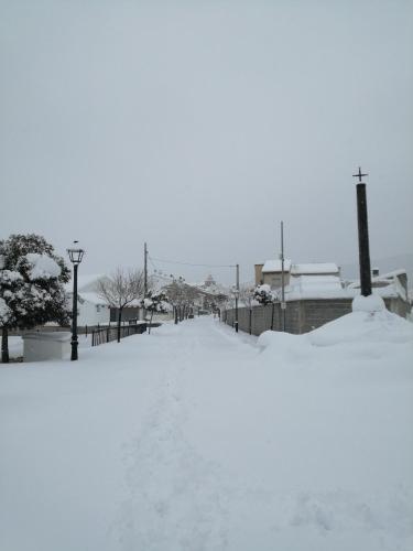 a snow covered street with houses in the background at Casa la Cisterna in Pina de Montolgrao