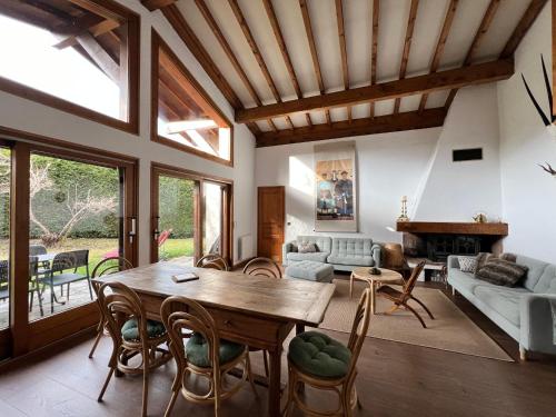 a living room with a wooden table and chairs at Chalet Mao in Megève