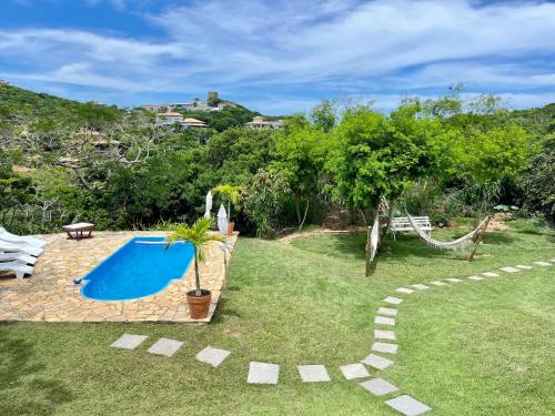 ブジオスにあるPousada Nomades Buziosの庭園(スイミングプール、ハンモック付)