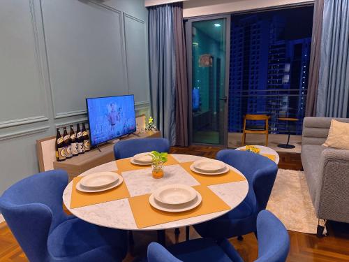 a dining room with a table and blue chairs at Bloomsvale Residence in Kuala Lumpur