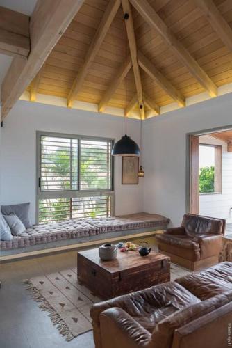 a living room with couches and a table in a room at Sunset 2 and sea view on St Eustache in Saint Barthelemy