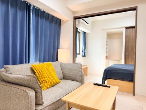 a living room with a couch and a bed at Triphome Tokyo Sugamo 2024 New 3 mins 2 stations in Tokyo