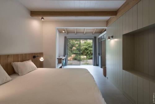 a bedroom with a large bed and a large window at Sunset 2 and sea view on St Eustache in Saint Barthelemy