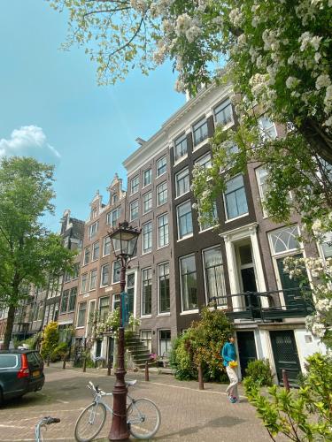 a bike parked next to a street light in front of a building at JoyJoyJoy the Green Palm ecolicious studio in a in historic Canalhouse from 1729 with view on the canals in Amsterdam