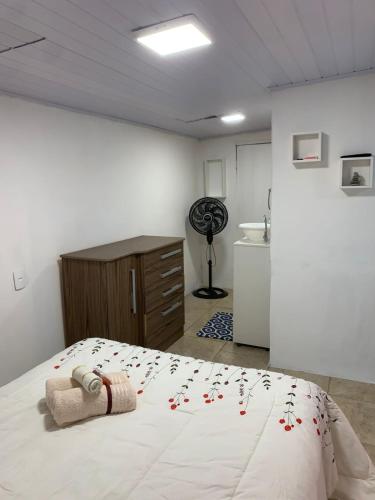 a bedroom with a bed with a towel on it at Mar Azul A&K - Sol e Mar in Penha