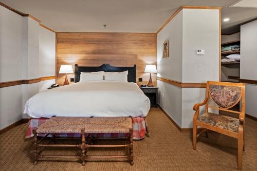 a bedroom with a large bed and a chair at von Trapp Family Lodge & Resort in Stowe