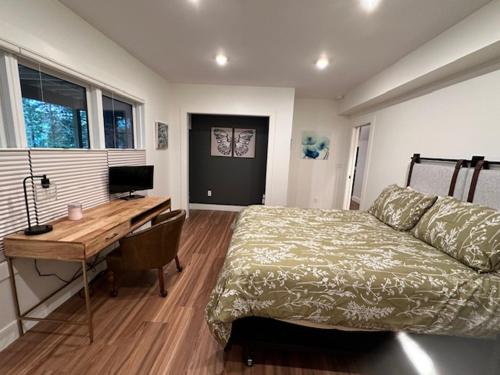 a bedroom with a bed and a desk with a computer at Paradox Lakeside in Paradox