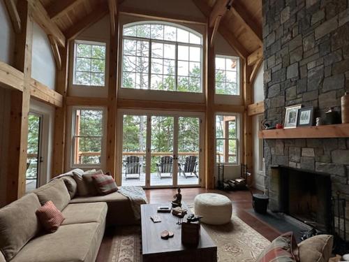 a large living room with a large stone fireplace at Paradox Lakeside in Paradox