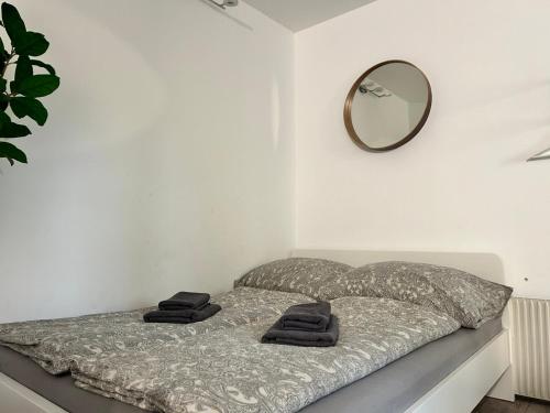 a bedroom with a bed with a mirror on the wall at Prime Suites near Schönbrunn Castle in Vienna