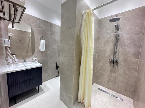 a bathroom with a shower and a sink at MegaPark Appartments in Almaty