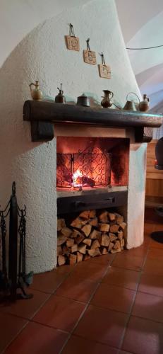 a stone fireplace with pots and pans on top at Hotel Schlair in Kremsmünster