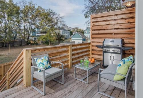 a patio with a grill and chairs and a table at Downtown 10 Beds Game Room Hot Tub Roof Deck in Nashville