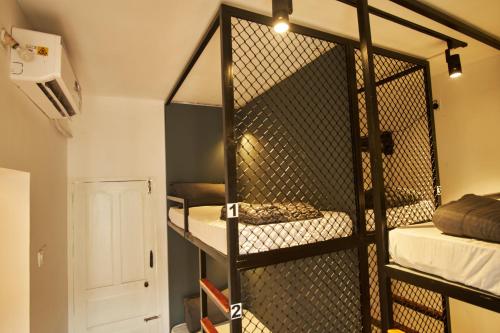 a room with a cage with two bunk beds at Cliff and Coral Varkala, North Cliff in Varkala
