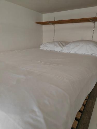 a large white bed in a white bedroom at Chez Nahiko STUDIO Paris Massy Palaiseau in Palaiseau
