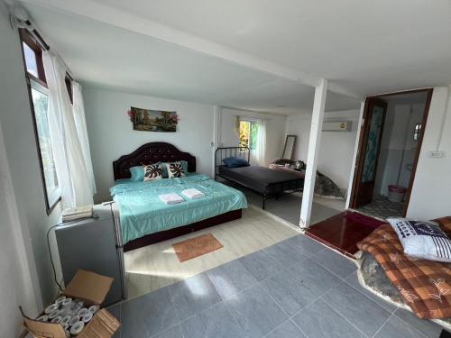 a bedroom with a bed and a living room at Rasta view Bangalows in Ko Chang