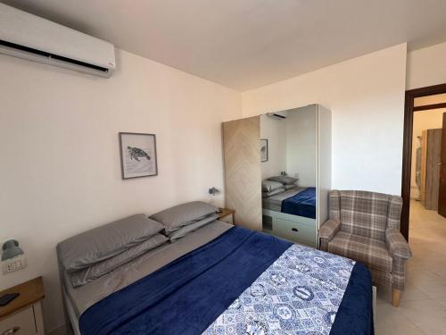 a bedroom with a bed and a chair at Blue Ocean Escapes in Santa Maria