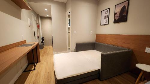 a small room with a bed in a room at Em frente à praia - conforto, localização e vista in Rio de Janeiro