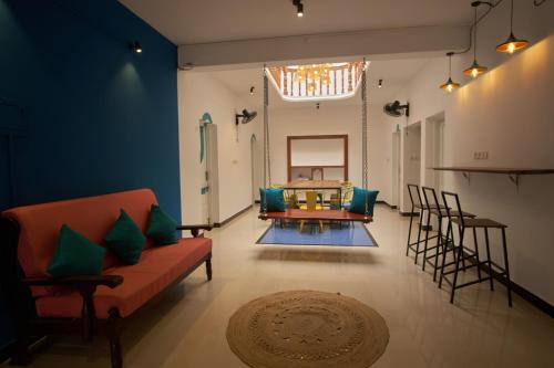 a living room with a couch and a table at Cliff and Coral Varkala, North Cliff in Varkala
