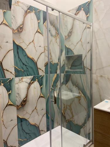 a bathroom with a shower with a stone wall at Maison Toledo 376 in Naples