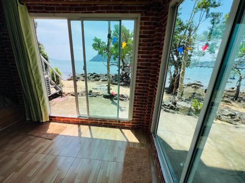a room with a window looking out at the ocean at Rasta view Bangalows in Ko Chang