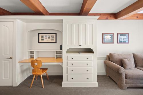 a room with a desk and a couch and a chair at von Trapp Family Lodge & Resort in Stowe