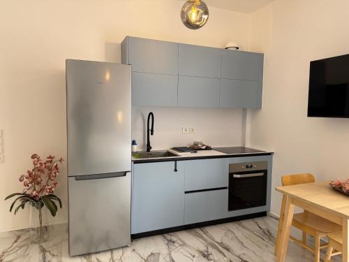 a kitchen with a large stainless steel refrigerator at Madi Luxury Stay Patra in Patra