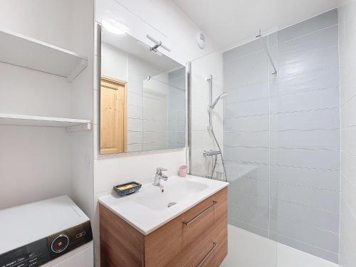 une salle de bain blanche avec un lavabo et un miroir dans l'établissement Snow Roc B302, à Saint-Jean-dʼAulps