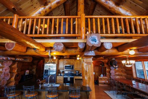 a kitchen and dining room of a log cabin at Log Retreat at Fish Creek by Simple Life Rentals in Fish Creek