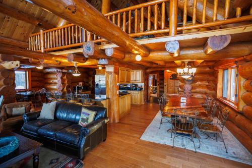 a living room with a couch and a table in a cabin at Log Retreat at Fish Creek by Simple Life Rentals in Fish Creek