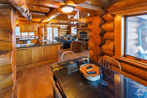 a dining room and kitchen in a log cabin at Log Retreat at Fish Creek by Simple Life Rentals in Fish Creek