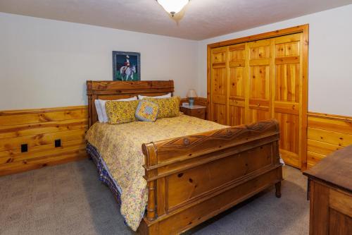 a bedroom with a wooden bed and wooden cabinets at Log Retreat at Fish Creek by Simple Life Rentals in Fish Creek
