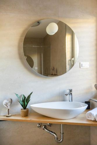 a bathroom with a sink and a mirror at Skalca Serenity Apartments Bled in Bled