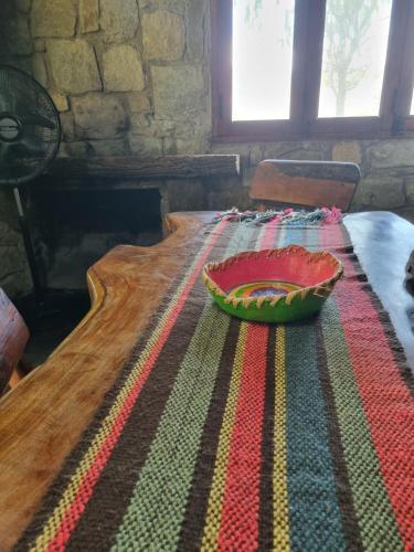 a bowl sitting on top of a table with a rug at Estancia Altos del Durazno in Estancia Grande