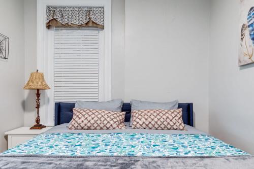 a bed with two pillows on it with a window at G5 KING BED central location museums FREE PARKING in Richmond