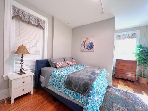 a bedroom with a bed and a dresser and a window at G5 KING BED central location museums FREE PARKING in Richmond