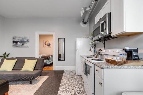 a kitchen and living room with a couch at G5 KING BED central location museums FREE PARKING in Richmond