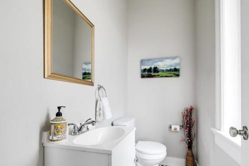 a white bathroom with a sink and a mirror at G5 KING BED central location museums FREE PARKING in Richmond