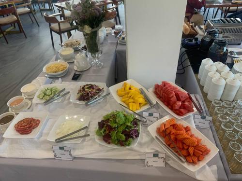 a table with several plates of different types of food at Homewood Hotel By Seuya Hotel in Siem Reap