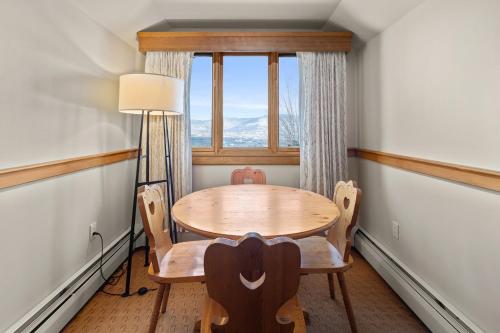 a table and chairs in a room with a window at von Trapp Family Lodge & Resort in Stowe